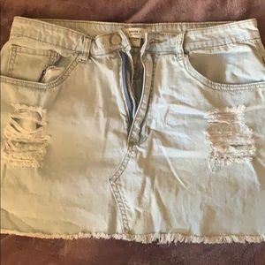 Mini skirt with rips in the pocket.